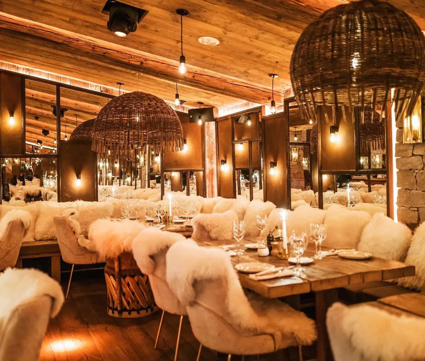 Cozy interior of La Ferme Saint-Amour nightclub in Courchevel, featuring warm lighting and inviting decor.