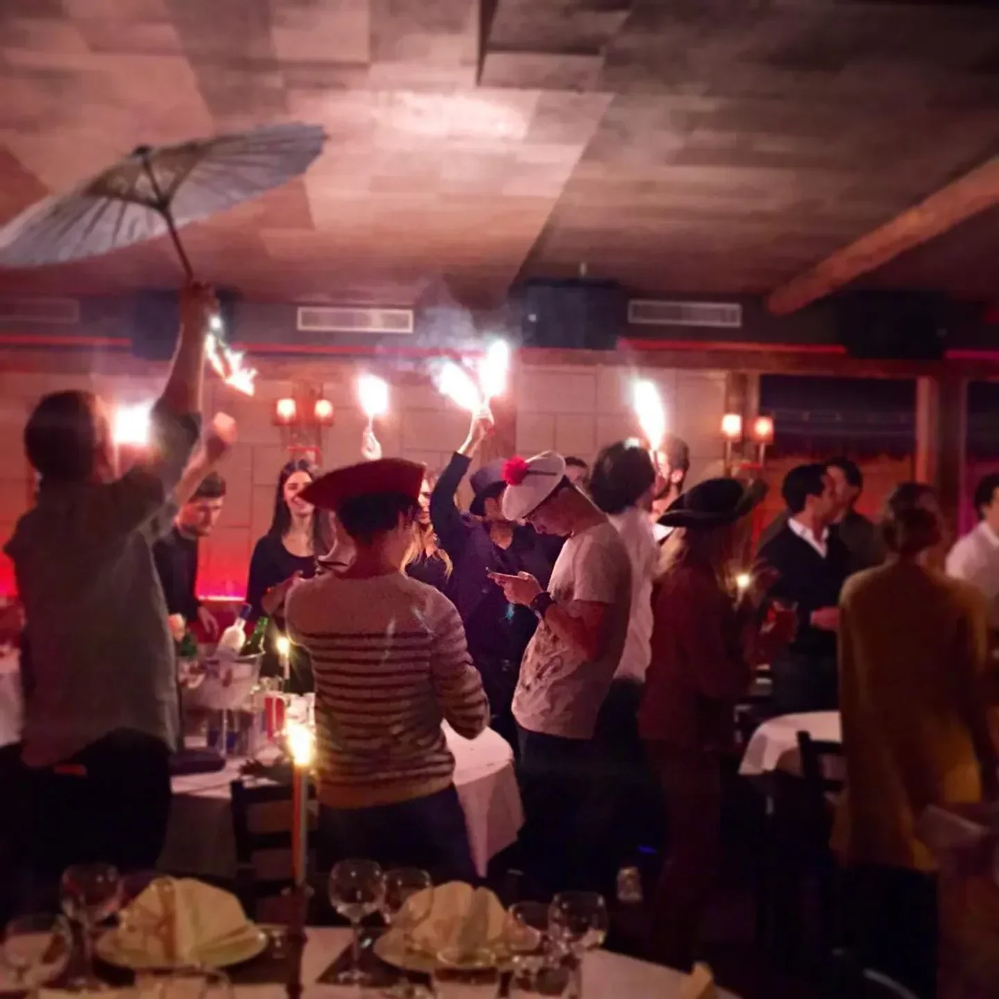 Festive night scene at La Mangeoire nightclub in Courchevel with dancing and sparklers
