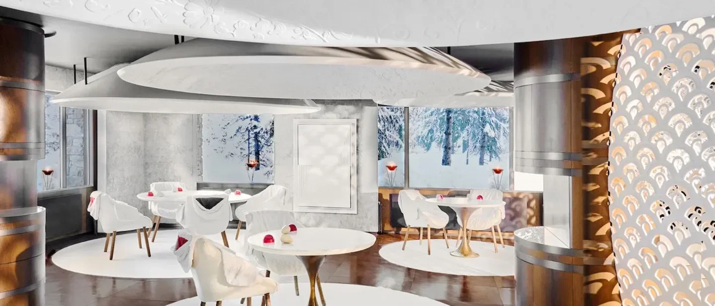 Elegant dining at Le 1947 à Cheval Blanc in Courchevel with snowy winter views.