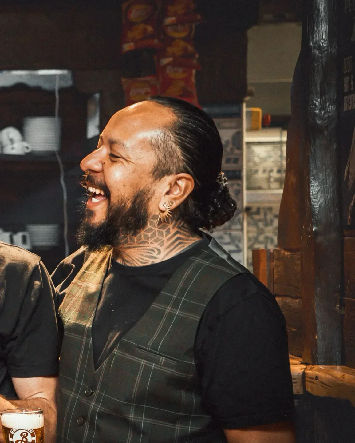 Happy patron at Le Pelican, luxury venue in Courchevel with a patterned vest.