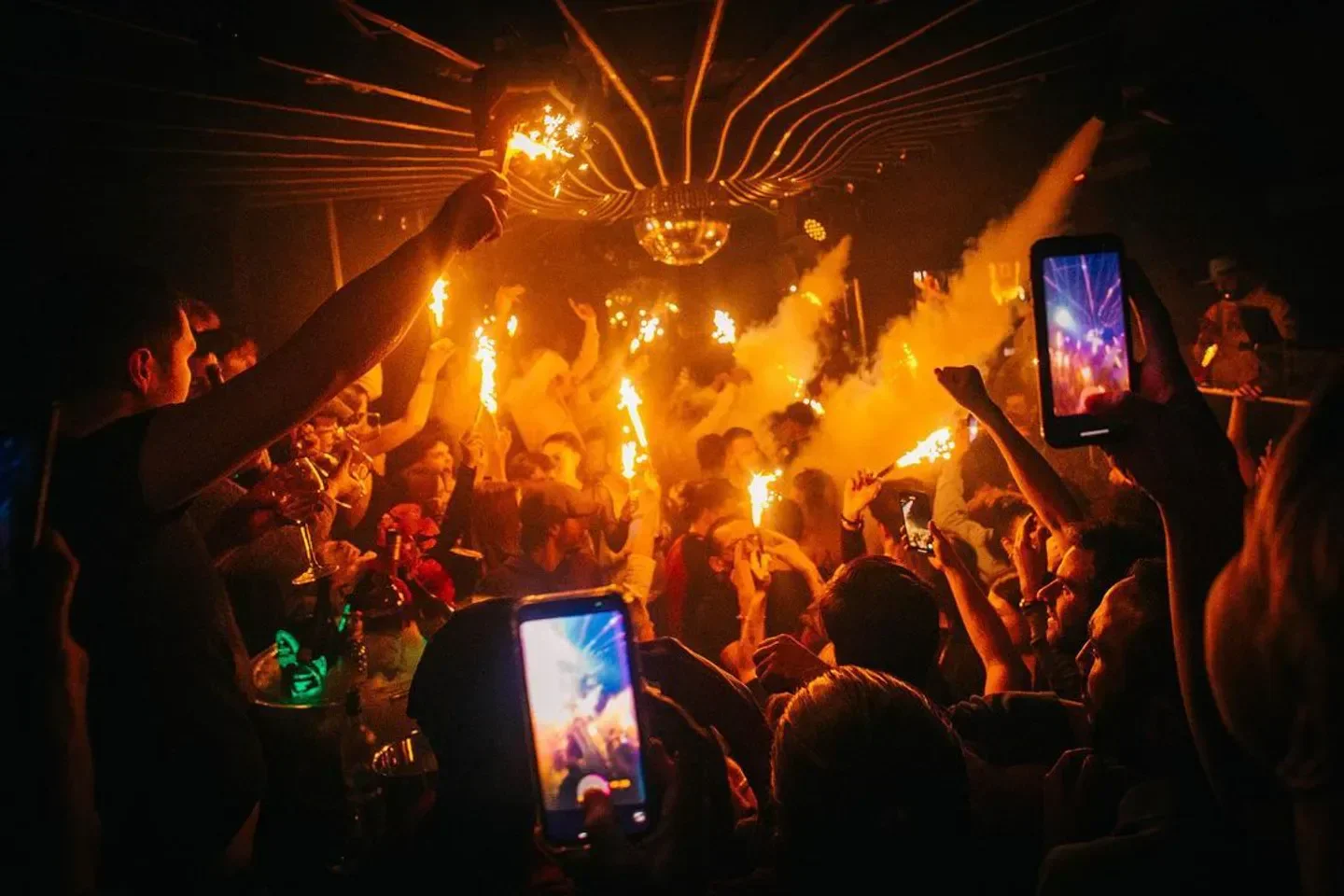 Energetic night at Les Caves in Courchevel with sparklers and party atmosphere